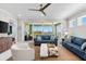 Bright living room with balcony, comfortable seating and water view at 388 Aruba Cir # 103, Bradenton, FL 34209