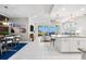 Open living area with modern lighting, tiled floors, and a seamless flow from the kitchen to the outdoor balcony at 388 Aruba Cir # 103, Bradenton, FL 34209