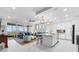 Bright and airy living room seamlessly flows into a modern kitchen, with balcony and water views at 388 Aruba Cir # 103, Bradenton, FL 34209