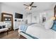 Bright main bedroom with a ceiling fan, television, dresser, and serene nautical decor at 388 Aruba Cir # 103, Bradenton, FL 34209