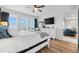 Bright main bedroom with hardwood floors, shuttered windows, and a view into the living room at 388 Aruba Cir # 103, Bradenton, FL 34209