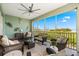 Relaxing screened patio with waterfront views, decorated with coastal-themed wall art at 388 Aruba Cir # 103, Bradenton, FL 34209