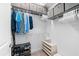 Organized walk-in closet with shelving, hanging rods, and storage bins to maximize storage space at 388 Aruba Cir # 103, Bradenton, FL 34209