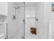Modern walk-in shower with sleek tile, a glass door, and a convenient built-in bench seat at 388 Aruba Cir # 103, Bradenton, FL 34209
