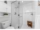 Bright walk-in shower with a glass door, sleek tile, and convenient built-in shelves for storage at 388 Aruba Cir # 103, Bradenton, FL 34209
