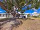 This backyard features a large shade tree, a screened-in porch and a well-maintained lawn at 3909 40Th W St, Bradenton, FL 34205
