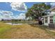 Expansive backyard featuring a serene pond, lush greenery, and a spacious area for outdoor enjoyment at 3909 40Th W St, Bradenton, FL 34205