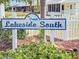 Welcome to Lakeside South: A community sign adorned with palm trees and a lake emblem, set amid lush greenery at 3909 40Th W St, Bradenton, FL 34205