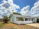 Low angle view of this single story home showcasing the well-manicured lawn and painted window trim at 3909 40Th W St, Bradenton, FL 34205