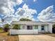 Charming single-story home featuring a bright turquoise door and well-maintained, white picket fence at 3909 40Th W St, Bradenton, FL 34205