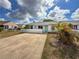 Charming single-story home featuring a well-maintained front yard and a vibrant, eye-catching entrance door at 3909 40Th W St, Bradenton, FL 34205
