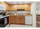 Efficient kitchen design with wooden cabinetry, essential appliances, and a clean, functional layout at 3909 40Th W St, Bradenton, FL 34205