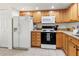 Functional kitchen featuring white appliances, ample cabinetry, and tile flooring at 3909 40Th W St, Bradenton, FL 34205
