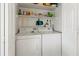 Convenient laundry room with washer, dryer, and storage shelves for organization at 3909 40Th W St, Bradenton, FL 34205