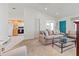 Inviting living room featuring a stylish sofa and open view to a modern kitchen at 3909 40Th W St, Bradenton, FL 34205