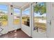 This is a bright porch area with views of the backyard, community pond, and nearby houses at 3909 40Th W St, Bradenton, FL 34205