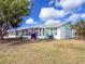 Back of property with a screened lanai, white paint, and pleasant backyard at 3909 40Th W St, Bradenton, FL 34205