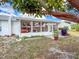 A home featuring an enclosed sunroom with multiple windows, and furniture, situated in a backyard at 3909 40Th W St, Bradenton, FL 34205