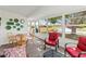 The sunroom includes ample seating, dining table, and views of the lush landscape and pond at 3909 40Th W St, Bradenton, FL 34205