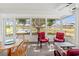 Cozy sunroom featuring lots of sunlight and a tranquil view of the pond and trees outside at 3909 40Th W St, Bradenton, FL 34205