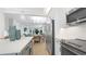 Bright, open kitchen with stainless steel appliances, and a view to living and dining areas at 4206 Saltwater Pearl Way, Cortez, FL 34215