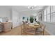 Open concept living space with dining area, and sliding glass doors leading to a covered outdoor balcony at 4206 Saltwater Pearl Way, Cortez, FL 34215