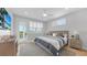 Comfortable main bedroom with a ceiling fan, outside balcony and plenty of natural light at 4206 Saltwater Pearl Way, Cortez, FL 34215