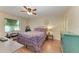 Serene bedroom features a ceiling fan, wood floors, and natural light from the window at 428 40Th W Ct, Palmetto, FL 34221