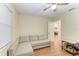 Cozy bedroom featuring a ceiling fan, laminate floors, and a comfortable sectional sofa at 428 40Th W Ct, Palmetto, FL 34221
