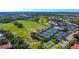 Aerial view of the golf course, clubhouse, tennis courts, and pool in Stoneybrook at 4640 Tower Hill Ln # 2325, Sarasota, FL 34238