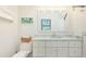 Bright bathroom with white vanity, framed mirror, and toilet at 4640 Tower Hill Ln # 2325, Sarasota, FL 34238