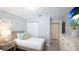 Bright bedroom with a twin bed, starfish decor, light walls and light, wood-look vinyl flooring at 4640 Tower Hill Ln # 2325, Sarasota, FL 34238
