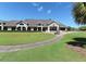 Expansive home exterior with lush green lawns, a long driveway, and picturesque landscaping at 4640 Tower Hill Ln # 2325, Sarasota, FL 34238
