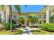 Charming condo featuring tropical landscaping, bright exterior, and welcoming walkway at 4640 Tower Hill Ln # 2325, Sarasota, FL 34238