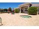 Outdoor hot tub near the community center, surrounded by seating areas with red umbrellas for shade at 4640 Tower Hill Ln # 2325, Sarasota, FL 34238