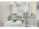 Cozy breakfast nook with white seating, marble-look counter, and contemporary lighting fixture at 4640 Tower Hill Ln # 2325, Sarasota, FL 34238