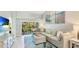 Bright living room with a plush sectional sofa, a TV, and access to the outdoor balcony at 4640 Tower Hill Ln # 2325, Sarasota, FL 34238