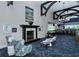 Spacious lounge area with a fireplace, piano, bar, and elegant seating under high ceilings at 4640 Tower Hill Ln # 2325, Sarasota, FL 34238