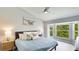 Light-filled main bedroom with ceiling fan, large bay window, and beautiful natural views at 4640 Tower Hill Ln # 2325, Sarasota, FL 34238