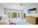 Bright main bedroom with ceiling fan, bay window, and a chest of drawers at 4640 Tower Hill Ln # 2325, Sarasota, FL 34238