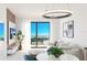 Bright living room featuring modern furniture, a stylish light fixture, and large windows offers a comfortable space at 4950 Remington Dr # 104, Sarasota, FL 34234