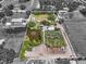 Aerial view of property featuring a pond, multiple structures, and flourishing vegetation in a unique setting at 5024 37Th E St, Bradenton, FL 34203