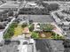 Aerial view highlighting home, a pond with a fountain, and a flourishing garden center in a quiet neighborhood at 5024 37Th E St, Bradenton, FL 34203