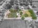 Aerial shot of property boasts a pond, greenhouse, and well-maintained land, ideal for various outdoor pursuits at 5024 37Th E St, Bradenton, FL 34203