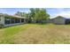 Large backyard featuring a well-maintained lawn, mature trees, storage shed, and potential for outdoor activities at 5024 37Th E St, Bradenton, FL 34203
