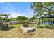 Scenic backyard featuring a pond view with a sitting area, water feature, and lush landscaping at 5024 37Th E St, Bradenton, FL 34203