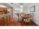 Open-concept dining area featuring wood floors, stylish chandelier, and seamless flow to the kitchen and living room at 5024 37Th E St, Bradenton, FL 34203