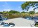 Dock with a boat, outdoor furniture and views of trees, water, and blue skies at 5024 37Th E St, Bradenton, FL 34203