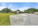 Well-kept home exterior with ample parking space, landscaped garden, and inviting curb appeal in a sunny setting at 5024 37Th E St, Bradenton, FL 34203