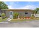 Cozy home exterior with well maintained landscaping, a neatly paved driveway, and inviting front entrance with bright red planters at 5024 37Th E St, Bradenton, FL 34203